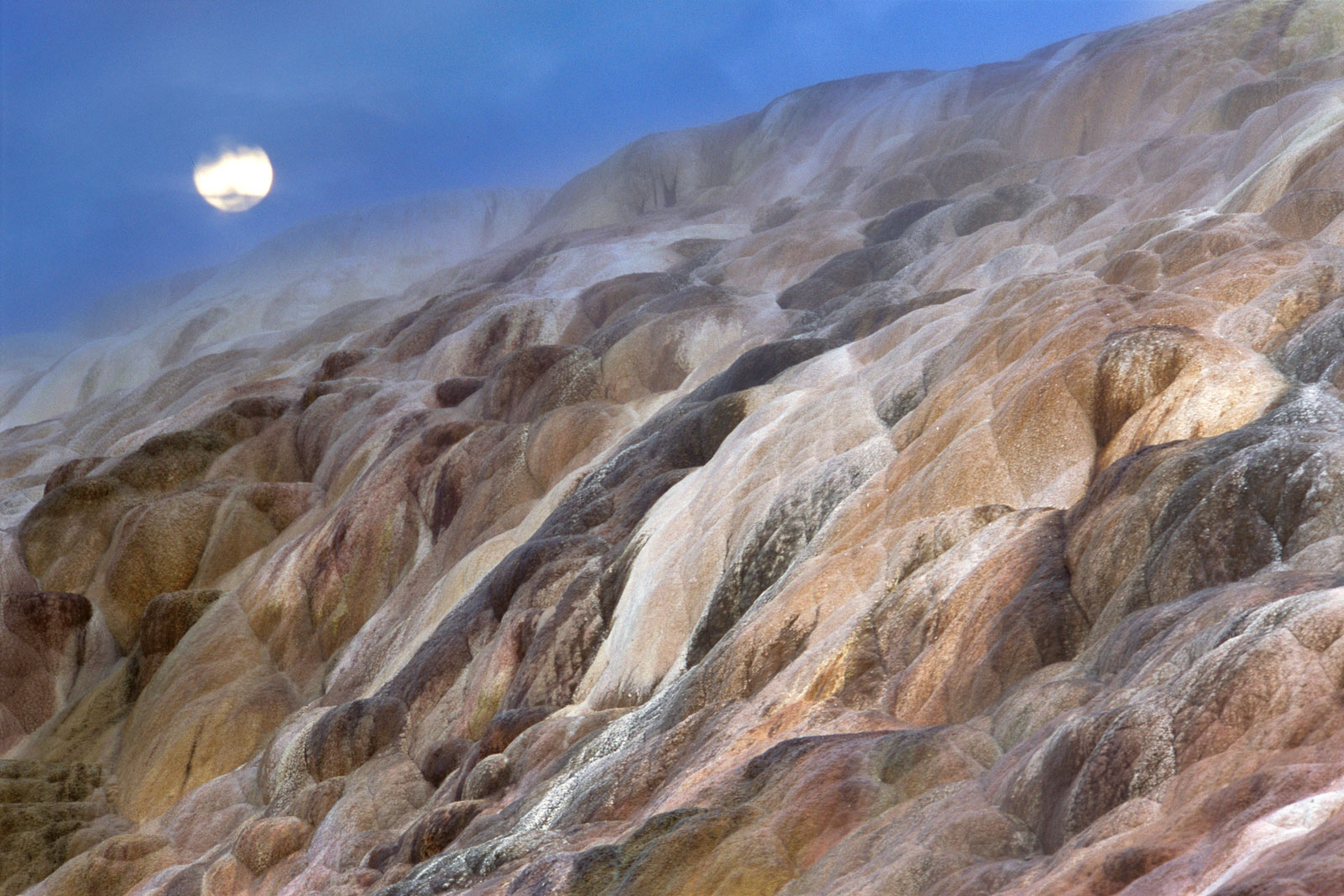 Moonrise over mineral terraces, Yellowstone National Park, Wyoming, USA